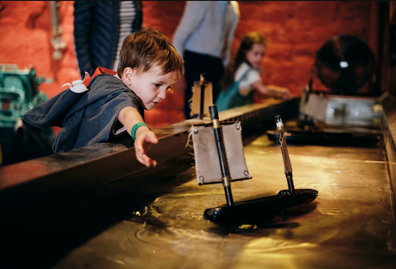 A boy exploring the Maritime Museum in Jersey - things to do in Jersey with kids